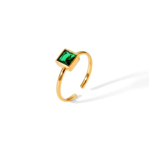 Detail of an 18k gold plated stainless steel ring with a square emerald green gemstone