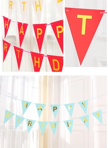 Detail of red and light blue birthday banners with gold foil letters for party decor
