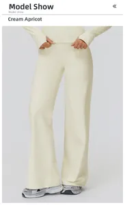 High-waisted creamy apricot wide leg pants styled in a minimalist sports outfit