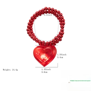 Detail of LED glowing heart pendant necklace with red beads for Valentine's Day