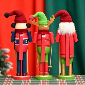 Three 30cm wooden Christmas nutcrackers including Santa and reindeer on plaid cloth