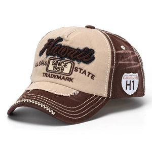 Close-up of vintage denim baseball cap with Hawaii embroidery and distressed brim details