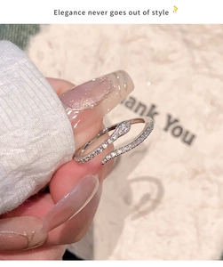Detailed view of a silver snake ring with sparkling cubic zirconia on a warm background