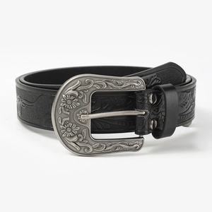 Detail of black leather belt featuring ornate silver floral embossed buckle and strap