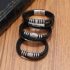 Detail showing three vintage braided black leather bracelets with silver magnetic clasps