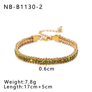 Macro shot of gold-plated stainless steel bracelet with green zircon gemstone inlays