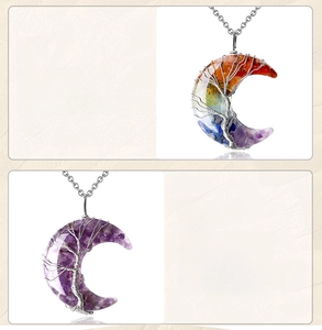Detailed close-up of crescent moon pendant with tree of life wire wrap and colorful stones
