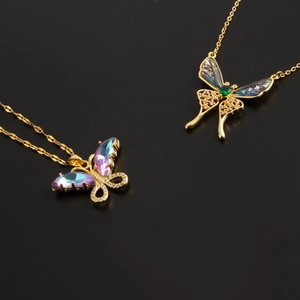 Elegant butterfly necklaces with colorful crystals and gold plating on black background
