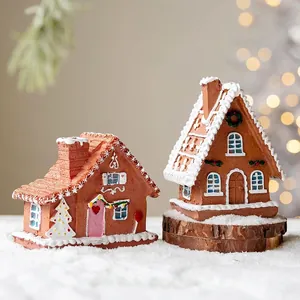 Miniature resin gingerbread house set with snowy details on Christmas table