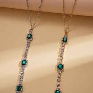 Luxe stainless steel necklaces with emerald-cut green gems in gold and silver finish