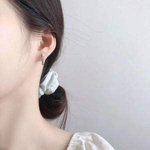 Elegant S925 sterling silver hoop earrings with cubic zirconia on a female model