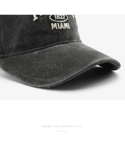 Macro view of vintage grey washed baseball cap featuring white 1822 Miami embroidery