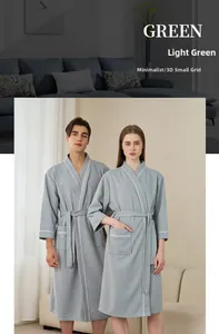 Detail of light green waffle robe showing kimono collar, belt, and white contrast piping