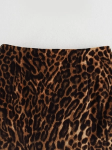 Close-up detail of leopard print mini skirt with soft plush fabric texture and waistline