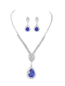 Detailed close-up of blue teardrop pendant necklace and matching crystal drop earrings