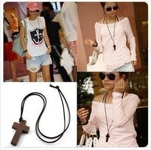 Detailed views of dark brown wooden cross necklace with black rope cord for Halloween style