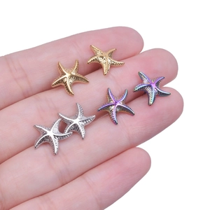 Detailed view of starfish stud earrings in gold, silver, and rainbow stainless steel