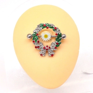 Close-up of Christmas wreath nipple ring with silver metal, red berries and green leaves