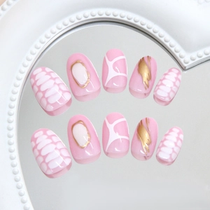 Pink press-on nails with golden mirror accents and white crocodile texture on mirror surface
