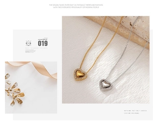 Detail shot of heart pendant necklaces in gold and silver with sparkling zircon stones