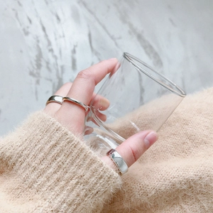 Minimalist silver geometric s925 rings set shown on hand holding a glass cup