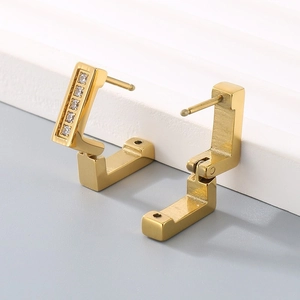 Luxury 18k gold plated L-shaped earrings with white zircon accents on gray platform