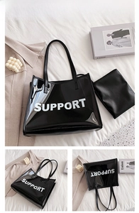 Macro detail of black transparent PVC jelly tote bag with SUPPORT lettering and inner pouch
