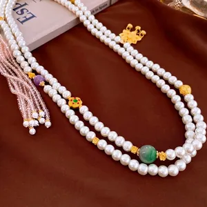 Double-layered gold-plated pearl necklace with lotus pendant and colorful gemstone beads