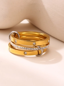 Detailed macro view of multi-layered mixed metal rings with sparkling zircon accents