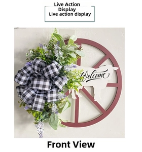 Detail of rustic Christmas wreath with red wheel, cow silhouette, and a Welcome sign