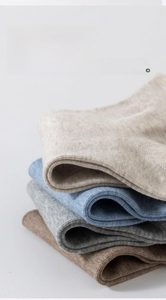 Close-up of breathable combed cotton socks stacked in earth tones for summer wear