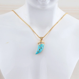 Detail of gold horn necklace with turquoise inlay and zircon stones on a white bust