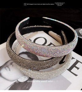 Detailed view of padded rhinestone headbands in iridescent, champagne and silver colors