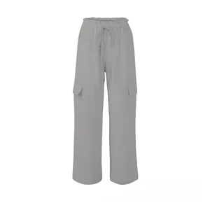Detailed view of elastic drawstring waist and flap cargo pockets on light gray linen pants