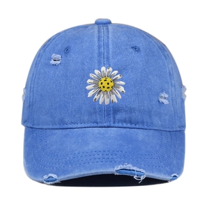 Vintage washed blue baseball cap with daisy embroidery and distressed ripped details