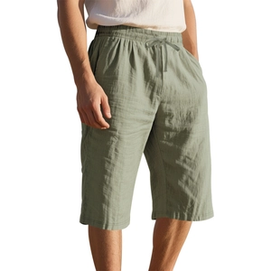 Close-up of linen shorts texture in bean green with drawstring and elastic waistband