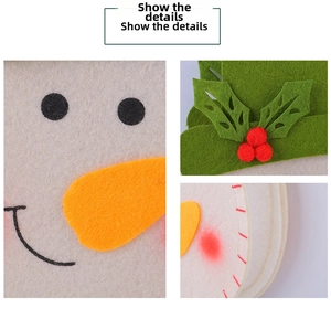 Detail view of snowman felt gift bag showing stitching, carrot nose and holly leaves