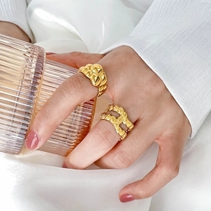 Detail of 18K gold plated lava fluid rings and woven chain design on model hand