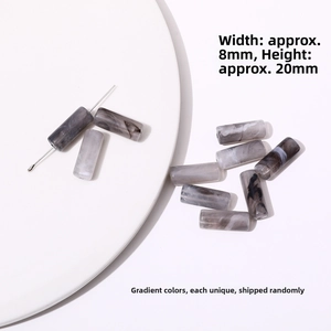 Macro detail of 20x8mm acrylic tube beads with marble texture for DIY jewelry making