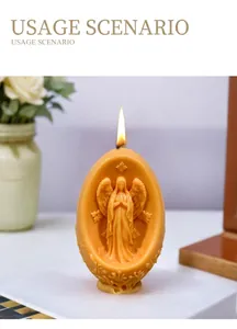 Detailed view of a lit amber Easter egg candle featuring a delicate angel relief carving