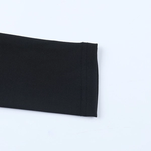 Close-up of cuff detail on black fitted fishtail dress showing premium sewing and texture