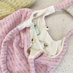 Detail shot of pink plaid plush tote bag interior with magnetic snap and inner pocket