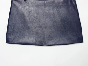 Close-up of deep blue faux leather fabric showing detailed grain texture and quality finish