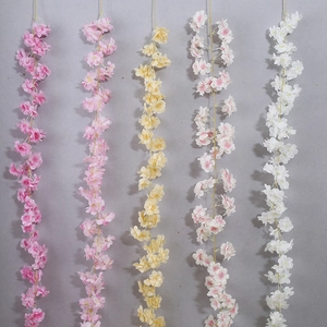 Detail of five artificial cherry blossom vines in pink, yellow, and white color options