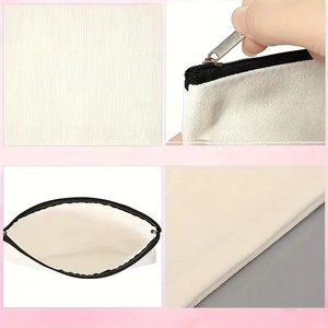 Detail view showing striped canvas texture and black zipper of the white cosmetic bag