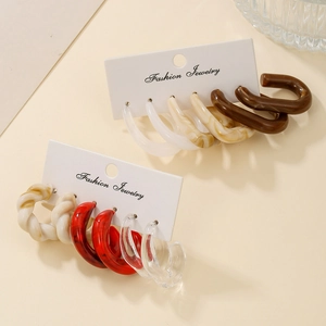 Flat lay of vintage C-shaped acrylic earrings in marble and twisted patterns set