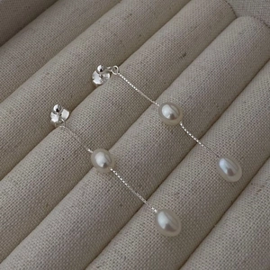 Elegant S925 sterling silver drop earrings featuring natural white pearls on delicate chains