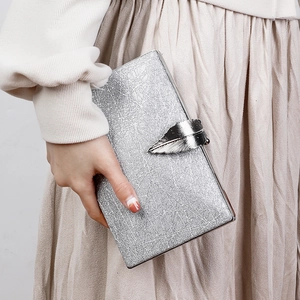 Silver evening clutch bag with leaf shaped metal clasp and textured finish for parties