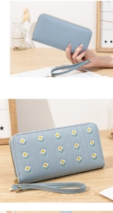 Close-up of light blue PU leather long wallet featuring floral embroidery and wristlet