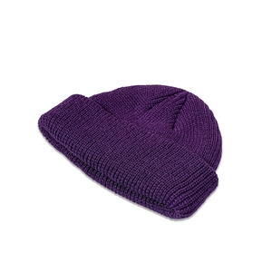 Close-up of dark purple knit beanie showing chunky texture and professional stitching